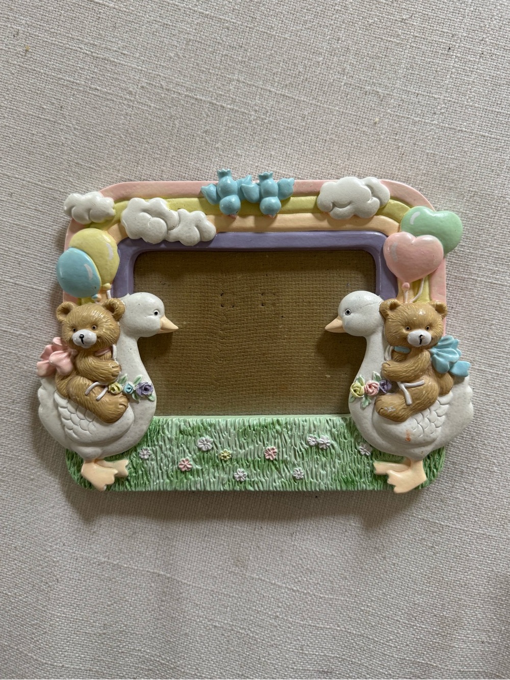 Vintage baby room bear and goose with rainbow picture frame
